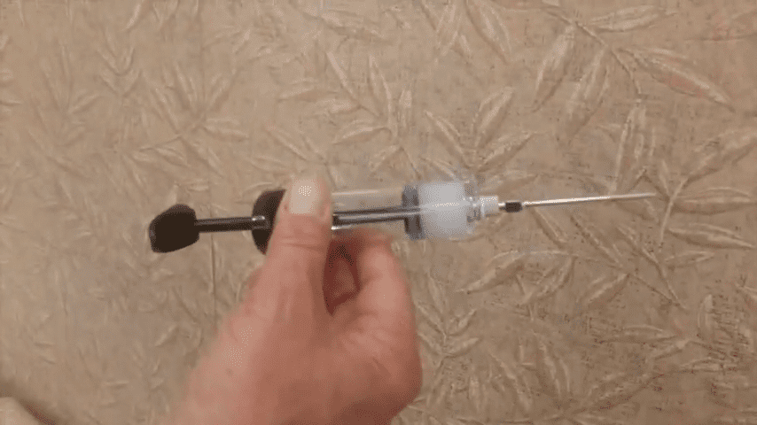 Wallpaper syringe in front of wallpaper bubble.