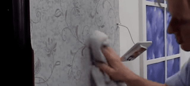 Hanging the First Strip of Wallpaper