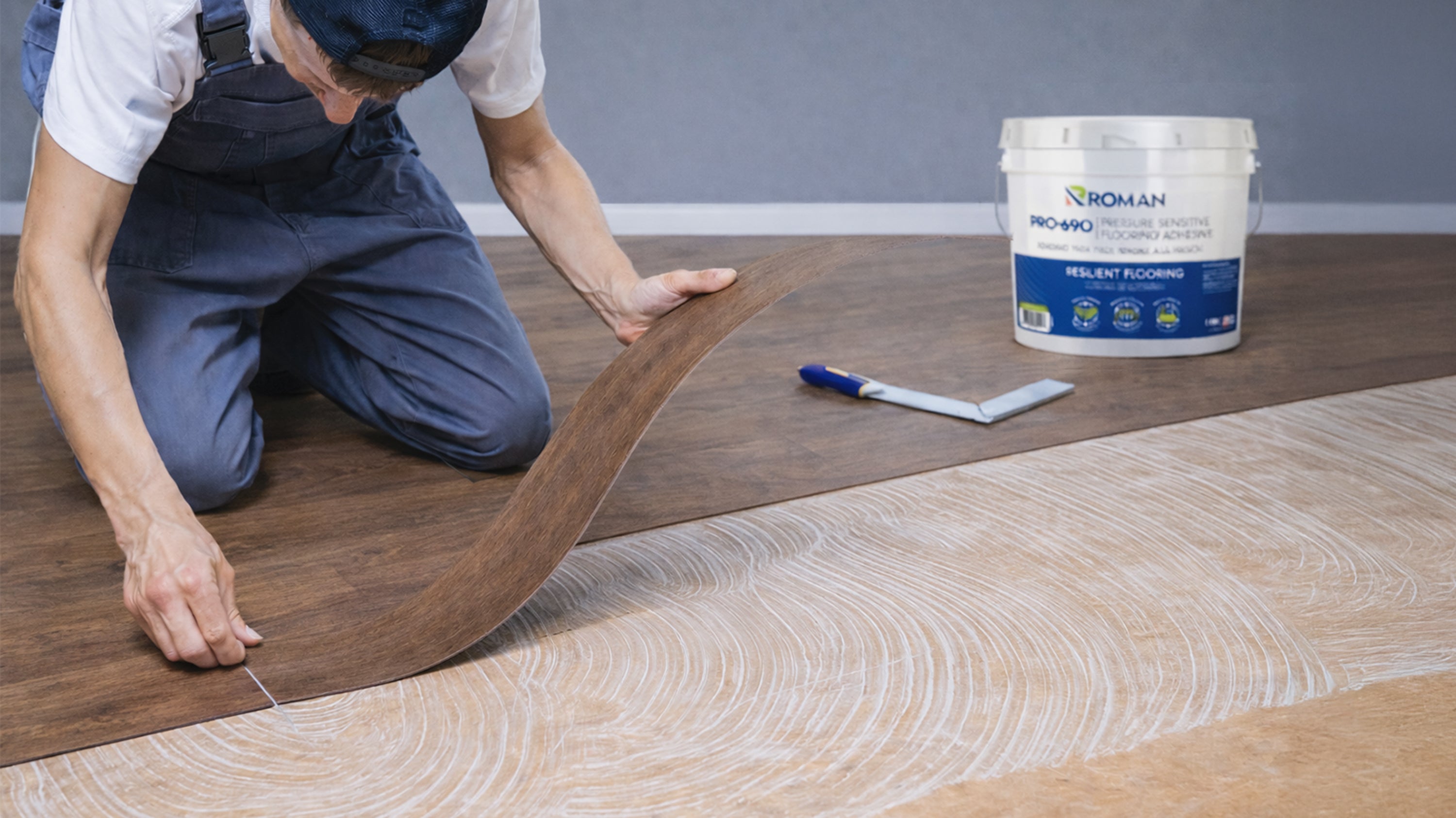 Flooring Installer Using ROMANs Flooring Adhesive