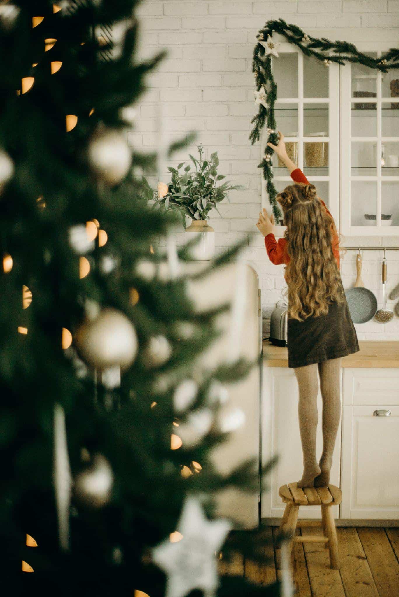 Little happy kid with Christmas tree